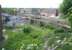 Photograph taken from alongside the A7 on 3 June 2011 looking south west over the site of the planned Newtongrange station on the Borders Railway route to Tweedbank. The houses of Jenks Loan in the background are part of a significant residential development on the west side of the trackbed here. The original Newtongrange station was located on the north side of the A7 behind the camera [see image 24342].<br>
<br><br>[John Furnevel 03/06/2011]