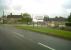 The old station building at Evercreech Junction (left of sign) and the former railway bungalows (right) have survived very well, but the hoarding advertising the industrial estate says far more about the fate of the 'Serene and Delightful'. Their logo is the wrong way round... but that's a small part of the overall problem.<br><br>[Ken Strachan 30/05/2011]