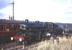 Ivatt 2-6-0 no 43063 running round the 11 coach <I>'Wansbeck Piper'</I> at Woodburn on 2 October 1966. The train, which ran from Newcastle Central via Morpeth, was double headed throughout by 43063+43000 running tender to tender (although the run round manoeuvre seen here required the locomotives to be separated due to the short remaining head shunt). The special had been organised by Gosforth Round Table to mark the closure of the Wansbeck Valley line, which by then terminated at Woodburn. [See image 21165]<br><br>[Robin Barbour Collection (Courtesy Bruce McCartney) 02/10/1966]