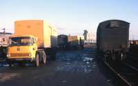 The ubiquitous yellow Bedford lorry (on hire from NCL) at Inverness Freight Depot in winter 1977. The rail vans have brought sacks of flour from the private siding of a Leith flour mill, for road delivery to Burnett's bakery in Inverness. All the sacks were individually 'hand-balled' from rail to road - tiring and dusty work, as the photographer's son can testify from his 1974-75 stint as a 'Railman' in Inverness.<br><br>[Frank Spaven Collection (Courtesy David Spaven) //1977]