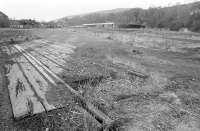 Looking north west over the remains of the old goods yard at Galashiels in 1975. The station site is in the centre background with Station Brae road bridge crossing left to right.<br><br>[Bill Roberton //1975]