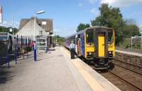 A single car Class 153 calls at Silverdale on 30 July with the 14.22  Northern Rail service from Lancaster to Carlisle via the Cumbrian Coast. The Silverdale village shuttle bus stands in the station car park on the left.<br><br>[John McIntyre 30/07/2011]