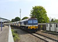 Hanson liveried 59103 <I>Village of Mells</I> drifting through Westbury with an aggregates train on 3 August 2011. A passenger line is to be relaid alongside this platform.<br>
<br><br>[Peter Todd 03/08/2011]