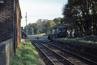 The former station at Bealings, on the East Suffolk line, photographed in November 1976, some 20 years after closure to passengers. The view is towards Woodbridge. The manual crossing gates and signal box lasted until the spring of 1984.<br><br>[Mark Dufton 07/11/1976]