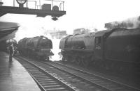 Stanier Pacifics 46225 <I>Duchess of Gloucester</I> and 46240 <I>City of Coventry</I> let off steam on the centre roads at Carlisle on 28 December 1963, while D323 stands at platform 3 with a Glasgow Central - Liverpool train.<br><br>[Robin Barbour Collection (Courtesy Bruce McCartney) 28/12/1963]