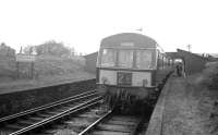 The last train to call at Throsk  - the 5.52pm Alloa-Glasgow Buchanan Street - pulls into the rudimentary Up platform on Saturday 16 April 1966. In conversation on the platform are the photographer's father and a fellow enthusiast. The latter and the photographer indulged in an on-the-train / off-the-train / on-the-train competition to claim the title of 'last ever passenger', with the photographer claiming this dubious accolade! <br>
<br><br>[David Spaven 16/04/1966]