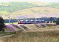 The 1400 Glasgow Central - Birmingham New Street Virgin Voyager heading south through the Clyde Valley on 5 August 2009 between Abington and Crawford.<br><br>[John Furnevel 05/08/2009]
