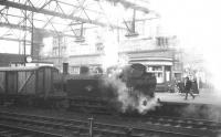 Steamed fish. The Carlisle station pilot, <I>Jinty</I> 0-6-0T no 47667, creates a bit of an atmosphere as it shunts a fish van in the station on 7 December 1963.<br><br>[K A Gray 07/12/1963]