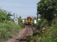 The Kessock Bridge almost frames 158720, as it negotiates the 10mph Clachnaharry swing bridge while heading west on a Kyle line service on 1 July 2011. This view was taken from the beer garden of the Clachnaharry Inn at the site of the long closed station. <br><br>[Mark Bartlett 01/07/2011]