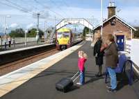 The 1155 hrs from Helensburgh Central to Edinburgh arrives at Cardross on 4 September 2011 to collect at least some of the passengers waiting on the platform. <br>
<br><br>[John McIntyre 04/09/2011]