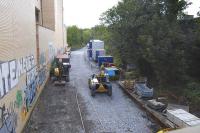 All that remains of Abbeyhill Station, seen looking south from London Road on 6 September 2011, with the site now in use as a work compound. Track is still in place, but is largely buried by infill, while the up platform makes a useful storage area. [See image 22469]<br><br>[Bill Roberton 06/09/2011]