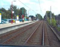 Photograph taken from the rear of a Metro service departing from Fawdon for Newcastle Airport on 10 September 2011. The train has just left from the staggered platform on the far side of the level crossing - the Newcastle bound platform stands on left. [See image 21036]<br><br>[Andrew Wilson 10/09/2011]