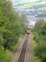 Pacer 142083 climbs the significant gradient out of Tonypandy on 15 September 2011 as it approaches Llwynypia station with the 14.36 Cardiff Central -Treherbert.<br><br>[David Pesterfield 15/09/2011]