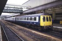The 07.10 DMU from Barnstaple arrives at Exeter St Davids on 9 May 1985 complete with attached GUV.<br><br>[Ian Dinmore 09/05/1985]