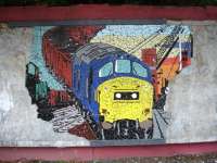 A tile mural section, depicting a past era of class 37s on coal trains in the Welsh Valleys, still relatively complete along the back wall of the Cardiff bound platform at Trehafod Station on the Treherbert branch in September 2011. <br><br>[David Pesterfield 14/09/2011]