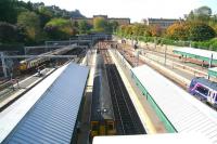 A September view west from Waverley Bridge, with an arrival from Milngavie on the left and departures for Dunblane and Glasgow Queen Street waiting at the platforms. In Princes Street Gardens the autumn colours have begun to appear.<br><br>[John Furnevel 27/09/2011]
