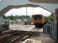A West Kirby to Liverpool service slows for its first call at Hoylake. 508141 approaches the art-deco station [See image 34460] over the level crossing and under the concrete footbridge.<br><br>[Mark Bartlett 11/06/2011]