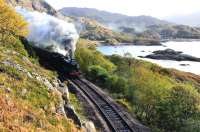 Leaving a smoke trail round the edge of Loch nan Uahm, Black 5 No.44871 builds up some speed on 11 October as it approaches the first tunnel on the 1 in 48 gradient of Beasdale Bank with <i> The Jacobite </i>.<br>
<br><br>[John Gray 11/10/2011]