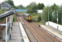 The west end of Falkirk Grahamston station on 25 July 2011, with the 14.28 Dunblane - Edinburgh Waverley service slowing on its approach to platform 1.<br><br>[John Furnevel 25/07/2011]