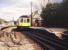 A DMU on the Plymouth - Gunnislake route stands at Bere Alston station in June 1991. The trackbed of the former line to Okehampton and beyond turns north east behind the train.<br><br>[Ian Dinmore /06/1991]