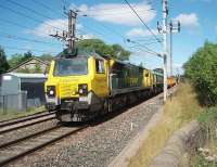 With the <I>Shanks Freightliner</I> liveried 66522 dead in train 70002 powers a rake of Network Rail mega-box ballast wagons south through the closed station of Bay Horse on 9 August. I had spotted this train, thought to be the 6U68 Carlisle Virtual Quarry to Mountsorrel, in Oubeck Up Loop waiting for a Voyager to overtake and just made it to Bay Horse in time to see it pass through. <br><br>[Mark Bartlett 09/08/2011]