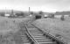 After closure of the main line, Longmorn Distillery, seen here in October 1978, adopted some of the former goods yard along with its internal rail network for movement of materials within the complex, powered by a Ruston Hornsby 48hp diesel shunter. On abandonment of the system, all track, wagons and locomotive, together with the station footbridge, were donated to the Strathspey Railway. [See image 27382]<br>
<br>
North end of the station (out of sight to left) with lifted goods yard on left.<br>
<br><br>[Bill Roberton 14/10/1978]