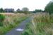 View north east along the trackbed near the former Fauldhouse and Crofthead station, taken in September 2009. The location is a little beyond the site of the junction for the mineral line to Levenseat quarry which ran off to the right. In the background are the houses of Croftfoot Drive and the bridge over the trackbed. These can also be seen in the former mystery image showing Scottish Rambler No 5 near this point 43 years earlier [see image 35804].     <br><br>[John Furnevel 09/09/2009]