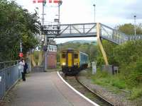 150280 runs into Tondu Station, to form the 15.31 service to Cardiff Central, after giving up the token from Maesteg to the Tondu Junction signaller at the nearby box. The two lower semaphore home signals cover the Maesteg line running straight ahead, and the Pontycymer line that branches off to the right by the signal box. <br><br>[David Pesterfield 15/09/2011]