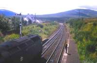 A brief exchange taking place with the driver of the Class 47 hauled <I>'Clansman'</I> as it waits in the sunshine for the road south from Dalwhinnie on a fine summer's day in 1976. Up ahead work is continuing apace on the redoubling of the Highland main line [see image 16458].<br><br>[Frank Spaven Collection (Courtesy David Spaven) //1976]