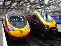 Virgin and CrossCountry train services stand side by side at Glasgow Central on 17 October 2011 awaiting their respective departure times for London and Penzance.<br><br>[John Steven 17/10/2011]