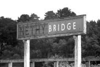 The station nameboard at Nethy Bridge in June 1974. The British Railways two part enamel sign was placed over the earlier sign after the raised letters were removed. Unfortunately, by the time the photograph was taken, part of the enamel sign had also been removed, leaving this strange combination.<br><br>[John McIntyre 15/06/1974]