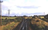 Looking north east towards Fearn station in the summer of 1974, with the line into the goods yard running off to the right. Photograph taken from the rear of an evening Far North Line train heading for Inverness.<br><br>[David Spaven //1974]
