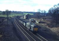 Eastbound coal empties run through the site of Curriehill station behind a Clayton on 13th February 1965. The original station here closed in 1951 but has since been replaced by a second, opened in October 1987. [See image 6939] <br><br>[Frank Spaven Collection (Courtesy David Spaven) 13/02/1965]