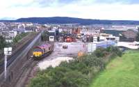 A Class 66 shunts Safeway traffic in the former coal yard at Inverness in 1999. The siding which formerly ran through to the harbour is on the extreme left. [See image 16325]<br><br>[David Spaven //1999]