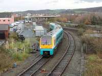 The 1450hrs Llandudno to Manchester service, formed by ATW 175105, leaves the branch at Llandudno Junction heading east. The tracks on the right are for Bangor and Holyhead with the large junction signal box on the left and the station beyond.<br><br>[Mark Bartlett 29/11/2011]