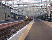 Class 380s on the west side of Glasgow Central on 2 December 2011. 009 is arriving on the left (platform 14), 113 waits to depart with the 1130 to Ayr from platform 13 and 010 is on the right at no 12 platform.<br><br>[John McIntyre 02/12/2011]