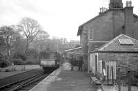 A railbus stands at the platform at Dalmellington on 3 November 1962 with a service for Kilmarnock. The vehicle is thought to be AC cars unit SC 79979 which ended its days as a grounded bodyshell on the Strathspey Railway at Aviemore before being scrapped [see image 36743].<br><br>[R Sillitto/A Renfrew Collection (Courtesy Bruce McCartney) 03/11/1962]