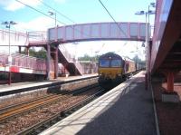 EWS 66112 takes a train of coal empties north through a pink-looking Whifflet station in August 2006.<br><br>[John Furnevel 24/08/2006]