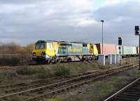 Freightliner 70007 turns north through Didcot with a container train from Southampton on 15 December.<br><br>[Peter Todd 15/12/2011]