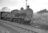 The small locomotive shed at Leighton Buzzard, a sub of 1E Bletchley, thought to have been photographed around 1959/1960. The 2-road shed stood to the south of Leighton Buzzard station on the up side of the WCML. It was officially closed in November 1962 and the site subsequently redeveloped.<br><br>[K A Gray //]