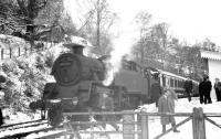 Platform scene at Loch Tay during the visit of the SLS/BLS <I>'Scottish Rambler no 2'</I> special on 12 April 1963. 80093 has just completed the run round manoeuvre and is about to take the train back to Killin Junction. [See image 36775]  <br><br>[R Sillitto/A Renfrew Collection (Courtesy Bruce McCartney) 12/04/1963]