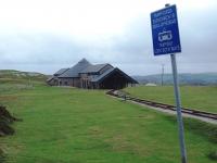 Halfway station on the Great Orme Tramway was completely rebuilt in 2001. This winter view (with haulage cables removed) from the nearby level crossing shows the lower station and tram shed on the upper section, with the exhibition hall, winding house and station of the lower section behind. The maximum gradient on the upper level is a moderate 1:10 but on the lower street running stretch it can be as steep as 1:3.8. <br><br>[Mark Bartlett 30/11/2011]