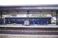 The single car diesel unit for Barnstaple waits at Exeter St Davids in May 1985. Note the BRUTEs and mail bags on the platform alongside.<br><br>[Ian Dinmore 15/05/1985]