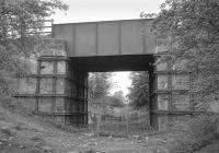 The B981 road bridge spanning the trackbed of the former branch running to Glencraig Colliery, Fife (closed 1966), which left the Bowhill line just beyond Bowhill Junction to the west of Cardenden. Photographed looking west in  May 1991.<br><br>[Bill Roberton 17/05/1991]