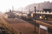 A train for the far north rolls into Dingwall station on a bright but hazy November morning in 1970 behind a pair of Inverness-based  Type 2 locomotives. Note the trolley load of milk churns standing on the platform.<br><br>[Colin Miller //1970]