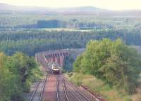 An early morning service from Inverness heads south through the closed station of Culloden Moor and joins the single track section. On the impressive viaduct over the River Nairn Turbostar 170434 will swing right and continue the climb onto the moorland ahead.  <br><br>[Mark Bartlett 01/07/2011]