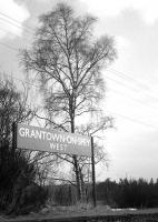 A fine surviving platform sign at Grantown-on-Spey West in April 1968, three years after complete closure.<br><br>[David Spaven /04/1968]