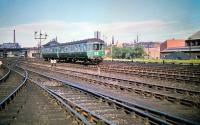 A 2-car DMU, bound for Corstorphine, is about to run west past Haymaket MPD on 4 July 1959. The roof of Haymarket Central Junction signal box can be seen above the second vehicle of the train. <br><br>[A Snapper (Courtesy Bruce McCartney) 04/07/1959]