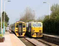 A Northern 158 pulls away from Hunmanby station on 21 April 2009 with the 0941 Sheffield - Scarborough service, just as a Network Rail weedkilling train arrives on the up line.<br><br>[John Furnevel 21/04/2009]