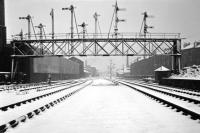 A scene which had been largely silent for several months by the time this winter 1965-66 shot was taken - looking west mid-way between Princes Street station and Dalry Junction along the closed Caledonian main line in Edinburgh. The only surviving traffic was trip workings to the Morrison Street coal yard, using the tracks on the far right, which ceased just a few months later.  <br>
Part of the Scottish & Newcastle brewery complex on Fountainbridge is on the left and Dalry Junction signal box can be seen in the distance. Nowadays this view is dominated by the Western Approach Road and the brewery is long gone<br>
<br><br>[David Spaven //1965]